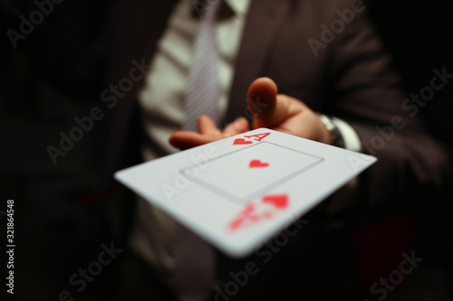 Trump in the sleeve, strategy business card game. Gambling cards, man suit throws card to floor. Man in suit throws card. Gambling creates annoyance and frustration. Player throws game.