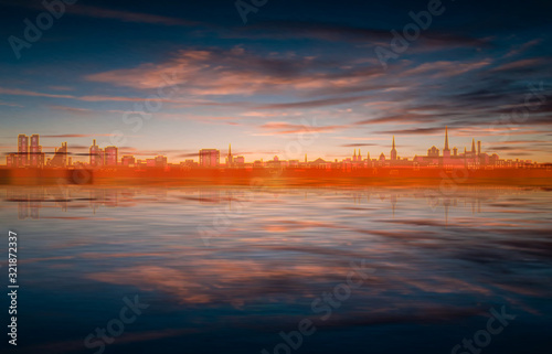 abstract spring background with blue brown sunset and silhouette of Tallinn