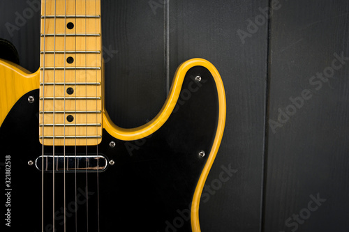 Close-up of classic electric guitar, neck with frets, microphone and steel strings
