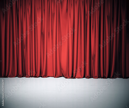 Stage with red curtain and concrete floor.