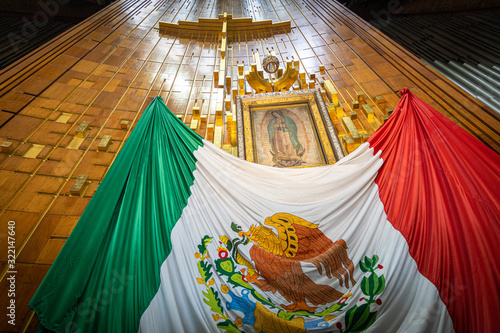 Our Lady of Guadalupe with mexican flag in Mexico City