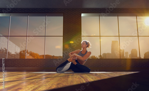 Yoga woman. Young woman doing yoga in loft on sunrise.