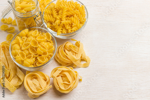 Raw wheat pasta on white background