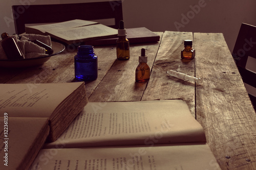 preparation of medicines and books on the wooden table.