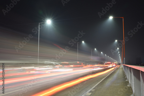 Rush hour traffic in Waihai bridge in Jiangmen at night. The car trails left on the road. 