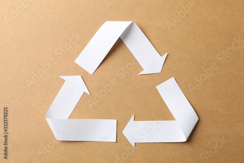 Recycling sign on craft background, top view