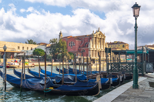 Venice, Italy. Gondolas moored on the Grand Canal and Church of Scalzi