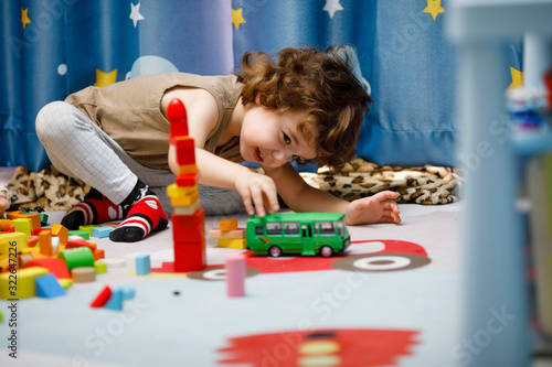 Little autistic boy playing with cubes at home