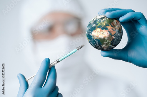 Pandemic concept, close up of scientist injecitng vaccine into the earth
