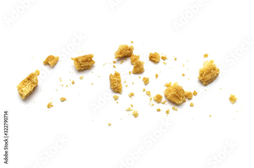 Scattered crumbs of butter cookies on white background.