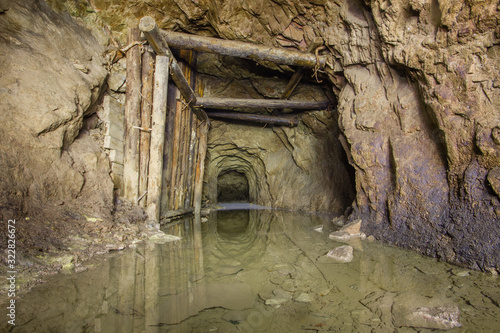 Old copper mine underground tunnel with wooden timbering