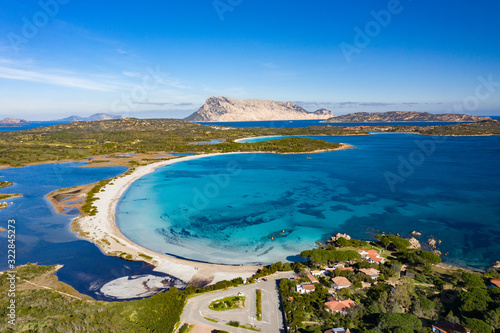 BEAUTIFUL AERIAL VIEW OF THE BEACH OF LU IMPOSTU WITH THE BACKGROUND OF THE ISLAND OF TAVOLARA