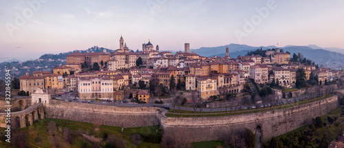 Bergamo, Italy. Drone aerial view of the old town during sunrise. Landscape at the city center, its historical buildings and the Venetian walls a Unesco world heritage