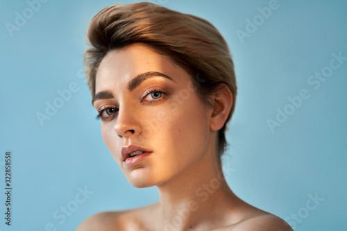 Beauty portrait of sensual blonde woman on blue background