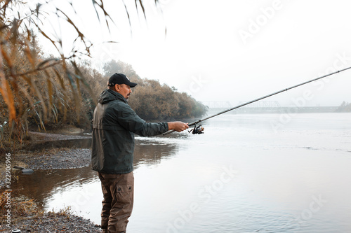 A man is fishing on the river. Fisherman on a morning fishing trip