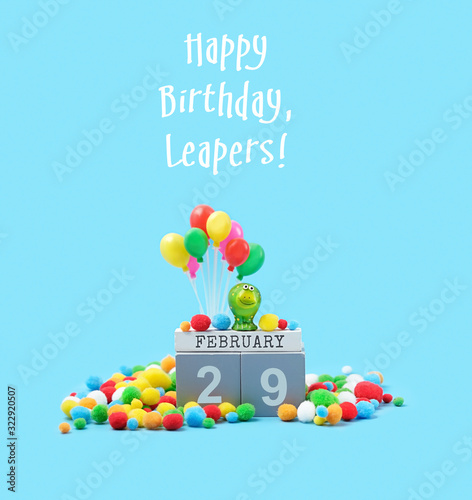 Happy Birthday, Leapers greeting card. February 29 date calendar, Frog, festive decor, balloons on blue background. leap day in leap year concept.