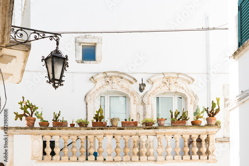 white house with balcony and cactus plants in Martina Franca, Italy