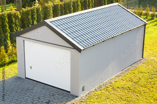 Installation of a new garage with metal elements in the garden
