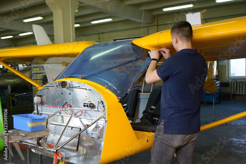 Fitter fixing windscreen on the cockpit of the sport aircraft