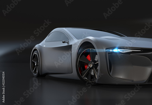 Metallic black electric powered sports coupe on black background with copy space. 3D rendering image. 