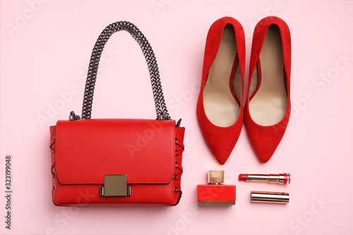Flat lay composition with stylish woman's bag and accessories on pink background