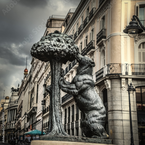 Grey sky over famous Bear and Strawberry tree statue in Madrid