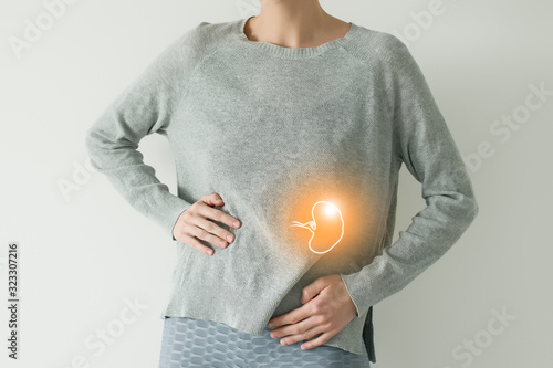 Woman in casual grey clothes suffering from indigestion pain, highlighted vector visualisation of spleen