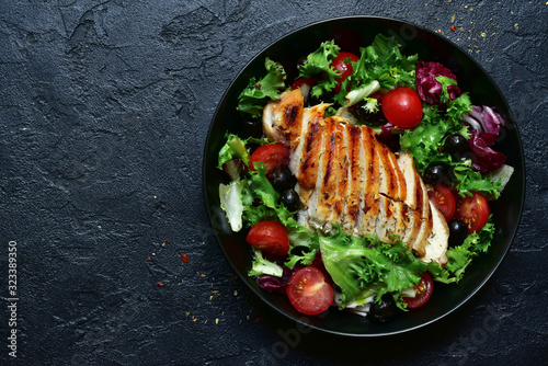 Grilled chicken fillet with vegetable salad. Top view with copy space.