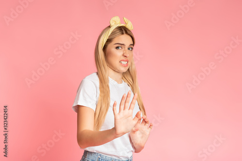 Shocked teen girl with disgusted face at studio