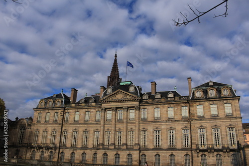 Historical Rohan Palace (Palais Rohan) with Cathedral of Our Lady (or Cathedrale Notre-Dame de Strasbourg) on the background in Strasbourg, France. It was built in 1730s.