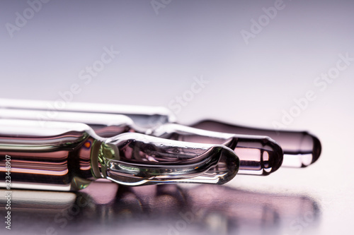 Ampoules on the table. Glass ampoules close up. Ampoules lying on the table with medicine.