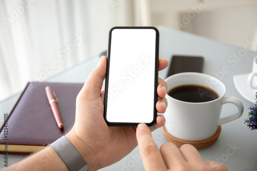 male hands holding phone with isolated screen in the office