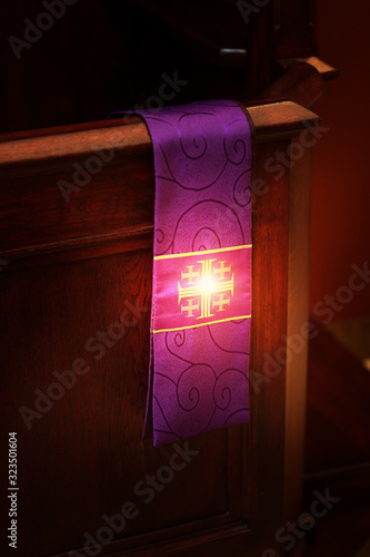 glow of the stole and the cross in the church