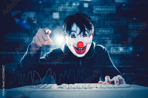 Man in clown mask pointing at cam in binary codes