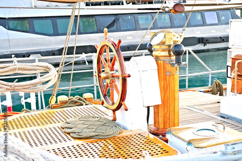 Steering wheel, helmsman station and steering compass on a classic sailing training vessel.