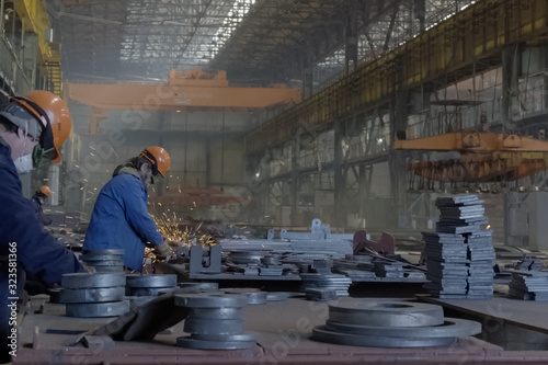 Workers grind the details at the shipyard.