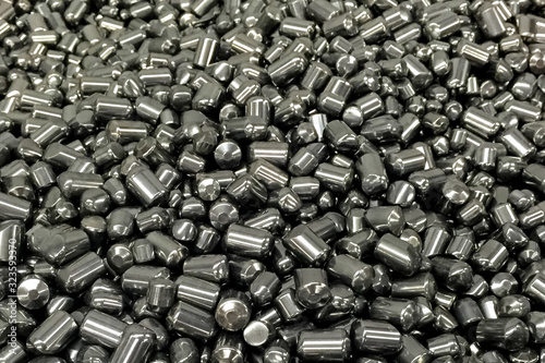 Tungsten cylinders. Ingots of tungsten in a pile.