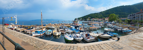 pictorial harbor with fishing boats and seaside promenade, health resort croatia