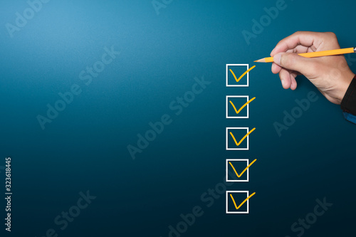 Orange marking on checklist box with pen, Checklist concept, copy space