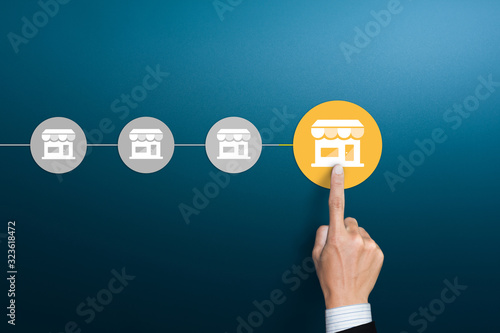 Franchise Business concept, Businessman hand choose franchise icon on blue background