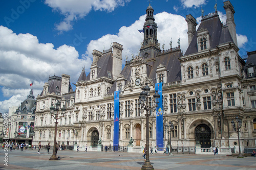 The Hotel de Ville - the city's local administration, Renaissance Revival style. Beautiful sunny day. Paris City Hall against the blue sky with white cumulus clouds.