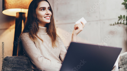 Girl using bank card for buying things online. Retail stores offering bonus cards for customers. Select items in web shop app, transfer money safely using sms code for payment.