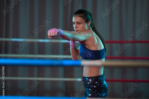 Female kickboxer shadow boxing