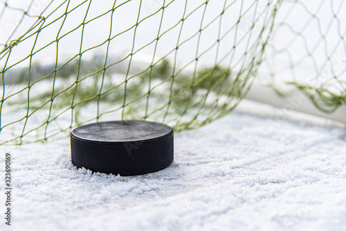 hockey puck in the goal net close-up