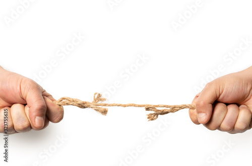 Two man are pulling old frayed rope in opposite direction with strength. Isolated on white. Compotetion in business concept.