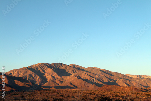 deep shadows desert mountains horizon blue sky