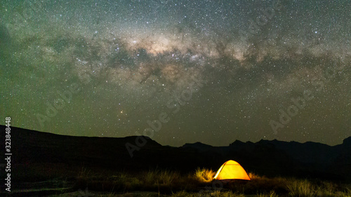 Yellow tent under the milky way stars