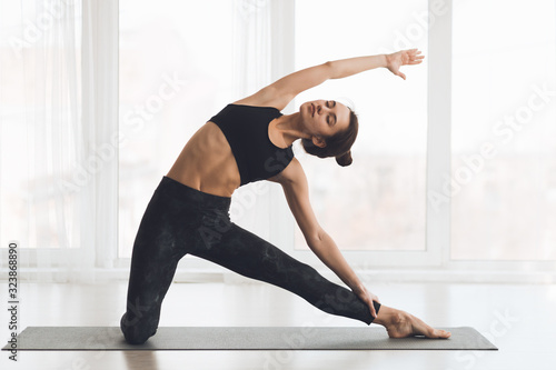 Relaxed girl streching arms and legs at home