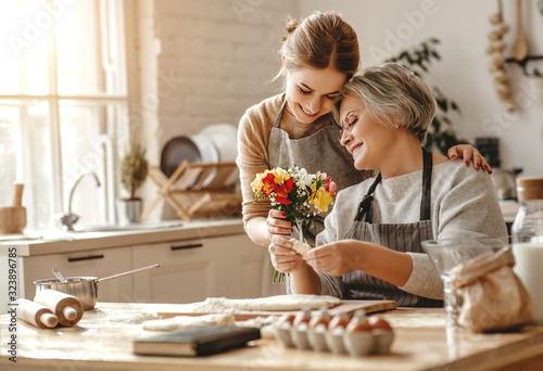 happy mother's day! family old grandmother mother-in-law and daughter-in-law daughter congratulate on holiday, give flowers .