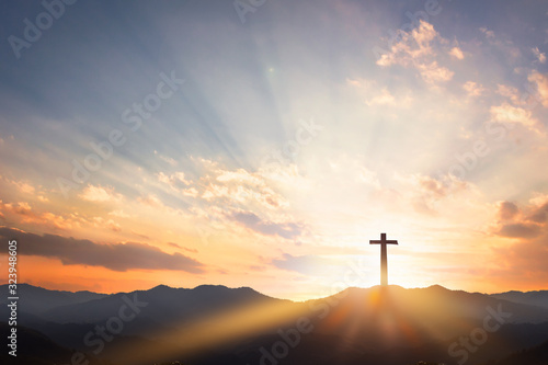 Good Friday concept: cross with sunset in the sky background